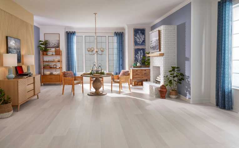 gray wood look flooring in modern living room with blue accent colors and wood decor